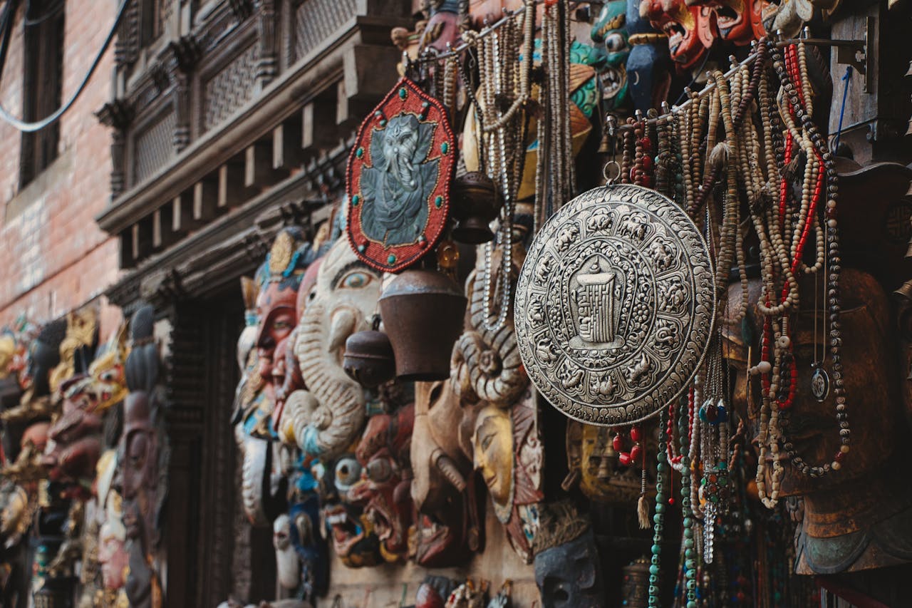 Intricate religious and cultural handicrafts on display in Kathmandu's vibrant street bazaar.