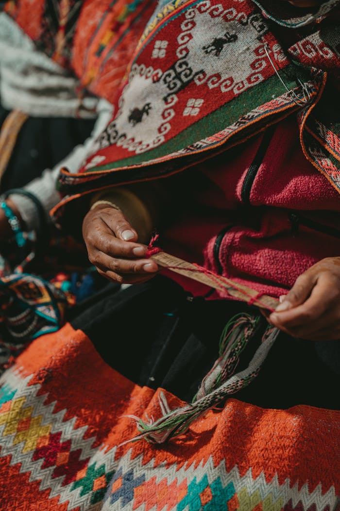 Close-up of Peruvian artisan weaving colorful textiles in Ollantaytambo, Cuzco.